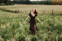 Happy teenage girl on a wild flower field