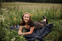 teen girl laying in a wildflower field
