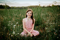 tween sitting in a wildflower field at prospect farms
