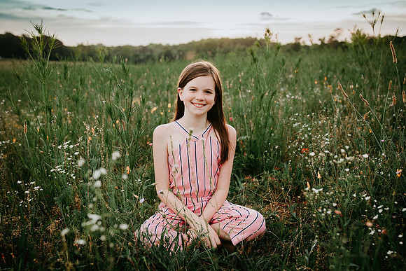 tween sitting in a wildflower field at prospect farms