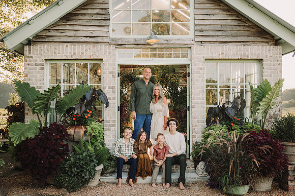 Family of six outside the greenhouse at West Milford Farm