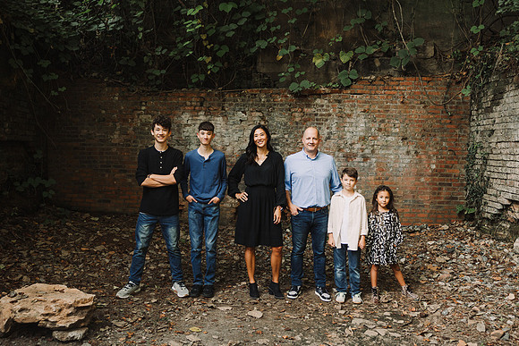 family of six stand in building ruins at Vickery Mill
