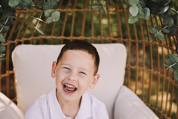 Smiling boy in a egg chair
