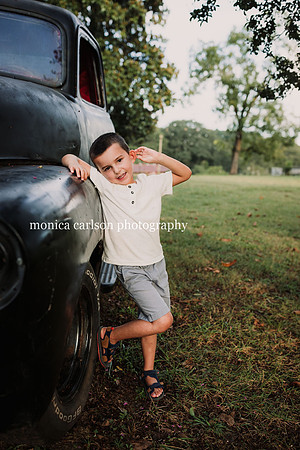 boy leaning against a antique truck in cumming, ga