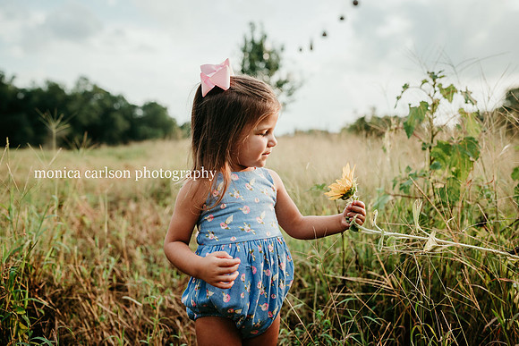 girl looking at a sunflower