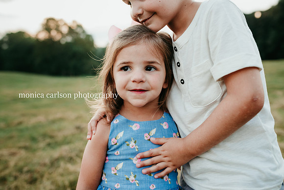 brother loving on his younger sister during a photo session
