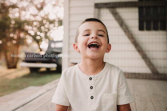 happy boy laughing at sunset on a farm
