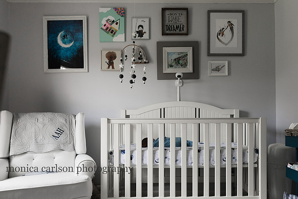 wide angle shot of a baby sleeping in his crib during a family photo session