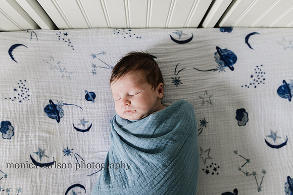 portrait of a sleeping newborn in his crib