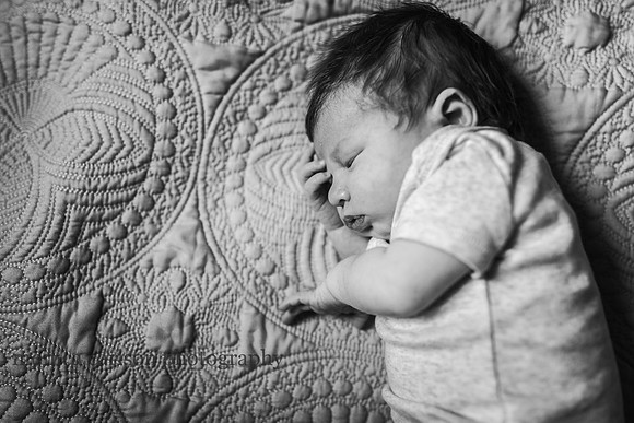 baby boy sleeping on his side during a in home newborn session