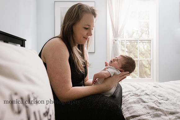 newborn boy with his mother on a bed