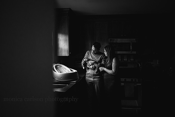 parents drying their son after a bath during a home session by monica carlson