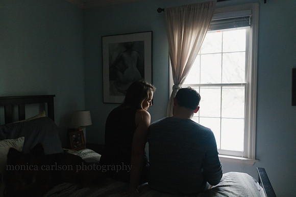new parents sitting by a window in their bedroom in Atlanta