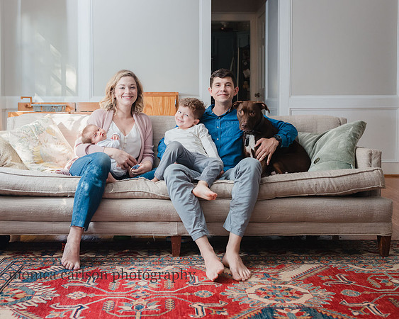 Family with a new baby sitting on their couch in Georgia