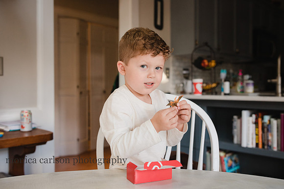 Boy eating chick fil a in his kitchen