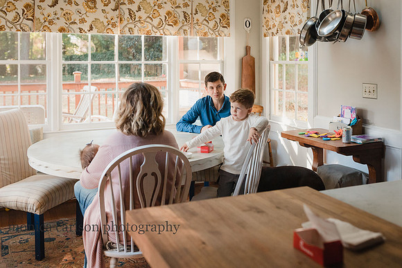 Family sitting around a table in their kitchen
