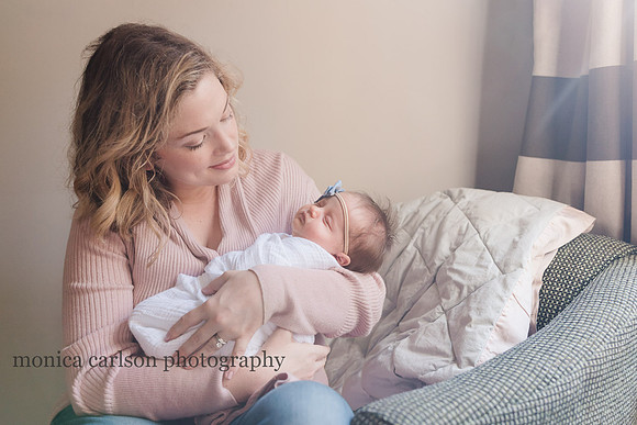 Mother holding her newborn baby during a photo session in alpharetta