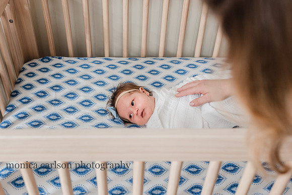 baby girl in her crib at a home photo session in Alpharetta