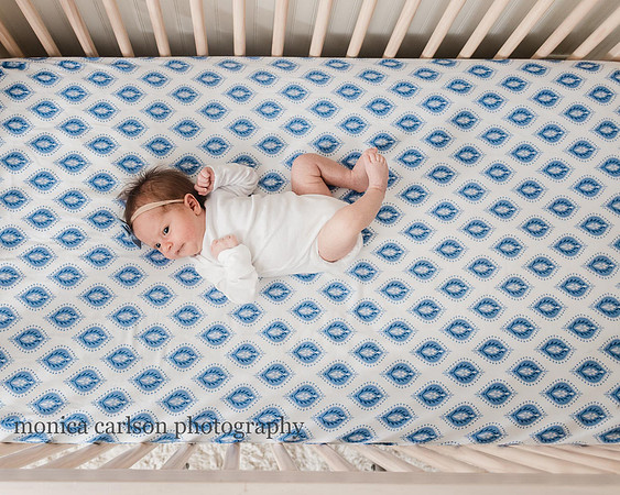 newborn laying in her crib in alpharetta, ga