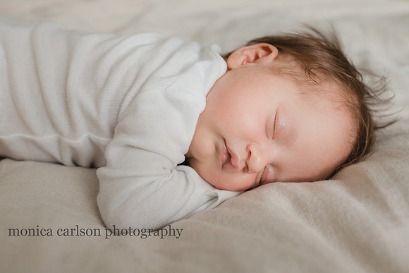 portrait of a sweet baby on a bed by monica carlson photography