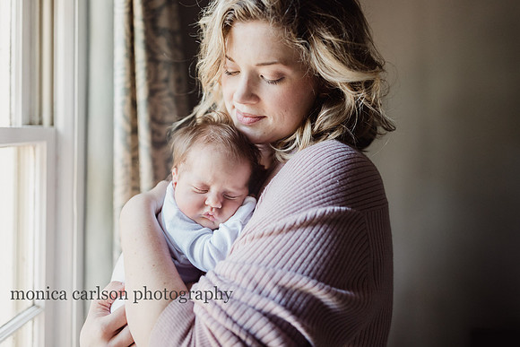 mother holding her baby by a window in Georgia