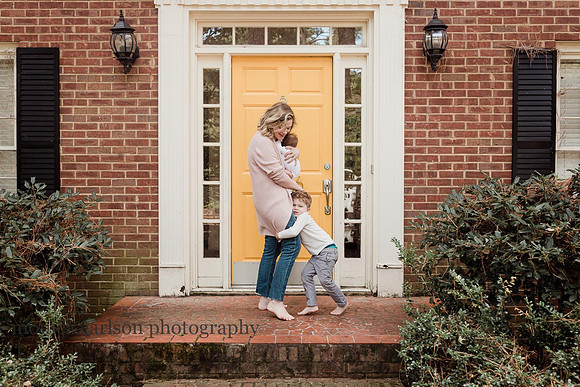 mom with her two children by her front door in Alpharetta