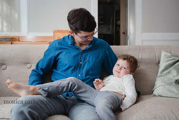 boy hanging out with his dad on the couch him in Atlanta