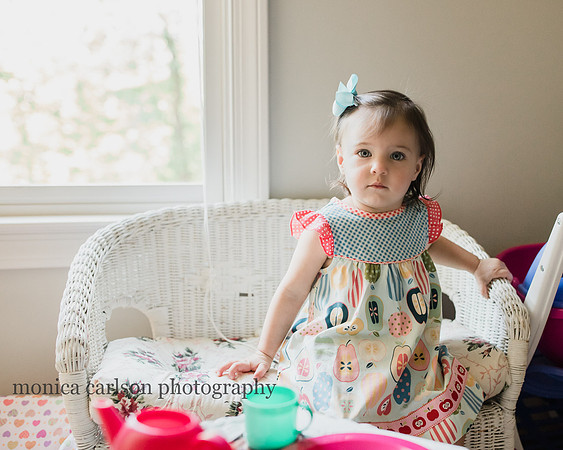 Little girl sitting in her playroom during a in home photo session
