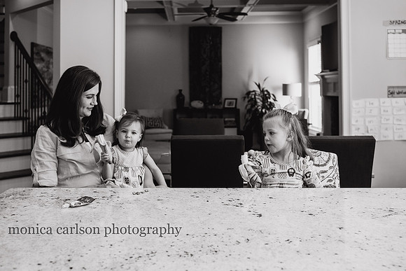 Mother sitting with her daughters in their home kitchen in Alpharetta