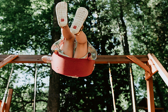 little girl on a swing in her yard outside atlanta