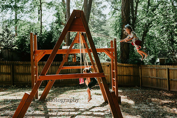 two girls on their backyard from a side view