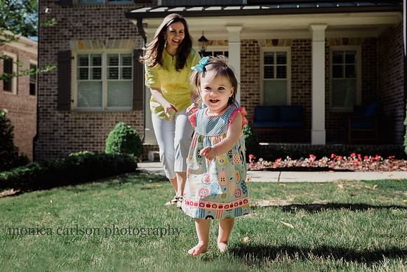 mother chasing her small daughter outside their home taken by monica carlson