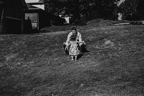 girl running to her father outside their house