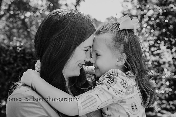 portrait of a mother and daughter giving eskimo kisses during a home photo session