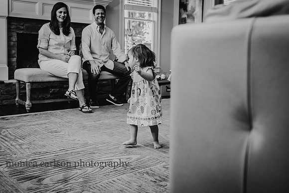 Parents watching their daughter dance in their living room in Alpharetta, GA