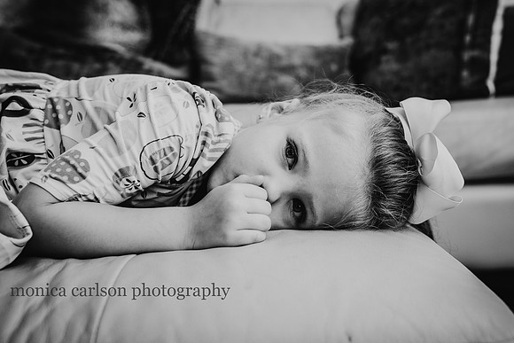 portrait of a tired girl laying down on a couch at home