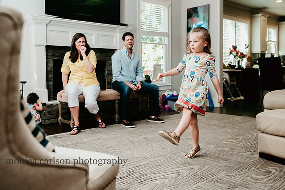 parents enjoying their daughters dance moves by monica carlson