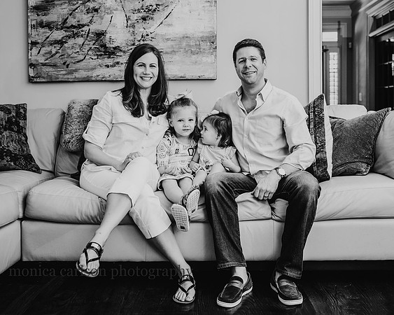 Black and white portrait of a family on their living room couch