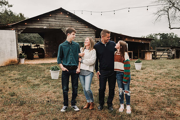 family of four sharing a laugh at Milford family farm