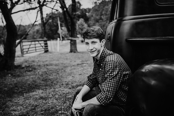 black and white portrait of a young man on a farm in cumming