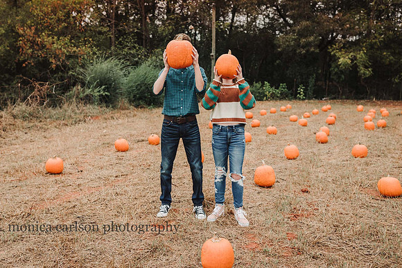 funny image of two teens holding pumpkins in front of their face