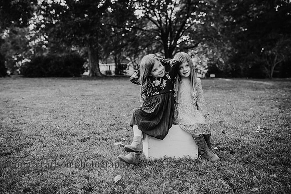 Sassy twin sisters sitting on a box in Roswell, Georgia