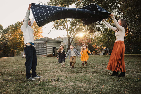 Family playing a game at sunset during a session with Monica carlson Photography