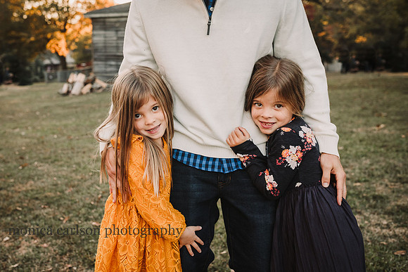 Twin girls hugging their father in Roswell during a family photo session