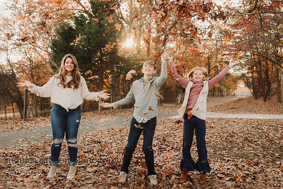 kids throwing leaves at mcdaniel family farm