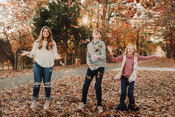 three siblings throwing leaves in a park in duluth, GA