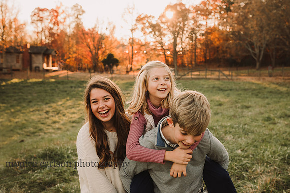 siblings enjoy a laugh during a family session with monica carlson