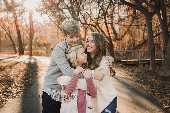 three siblings hugging each other in Duluth, GA