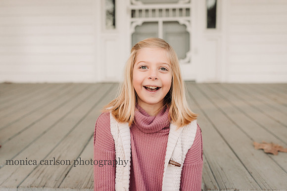 portrait of a happy tween blonde girl by monica carlson