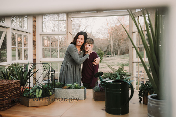 Mother and son hugging in a greenhouse